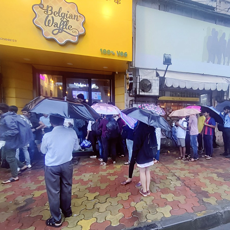 The Belgian Waffle Co’s National Waffle Day extravaganza draws massive crowds despite heavy downpour